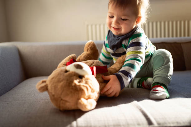 istock Playful baby boy with teddy bear 1313732715