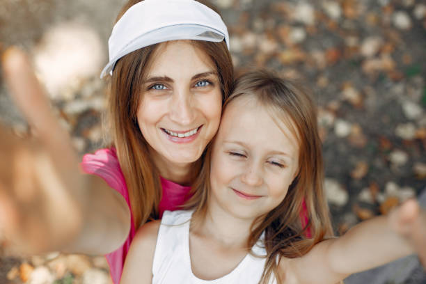 istock Mother with daughter playing in a summer park 1313733432
