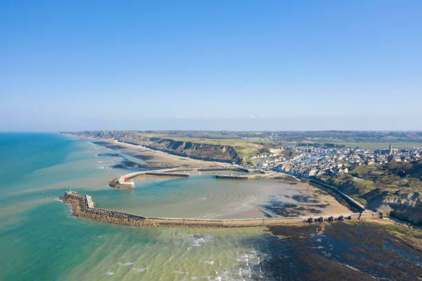 The beach, the port and the of the port in Bessin in France, in Normandy, in the Calvados, on the edge of the English Channel. stock photo