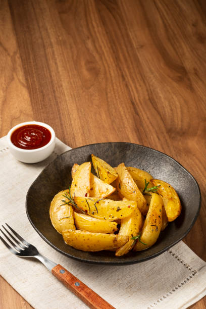istock Roasted potatoes with rosemary on the plate. 1313733655