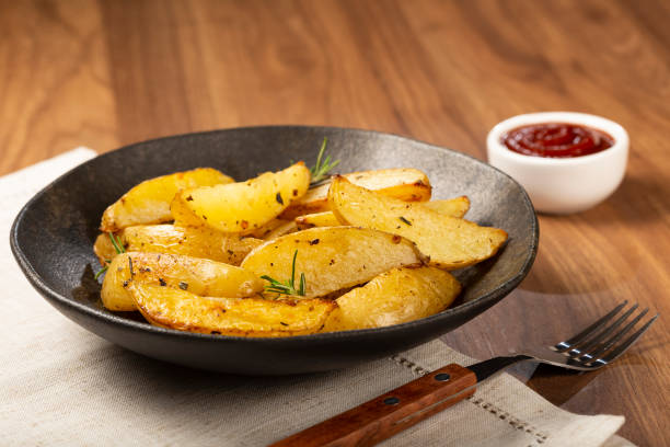 istock Roasted potatoes with rosemary on the plate. 1313733658