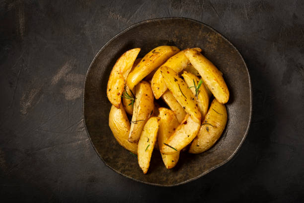 istock Roasted potatoes with rosemary on the plate. 1313733713