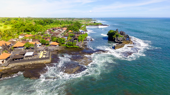 Tanah Lot Temple with big ocean waves crash. Landmark Tourism Bali