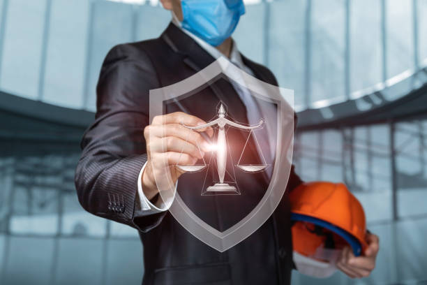 istock Construction worker in a protective mask clicks on the symbol of protection justice. 1313739829
