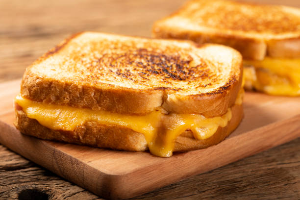 istock Grilled ham and cheese. Sandwich with cheese and ham on grill. 1313739978