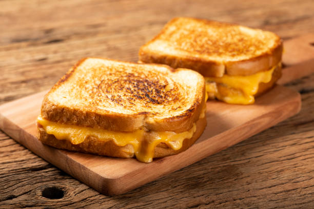 istock Grilled ham and cheese. Sandwich with cheese and ham on grill. 1313739986