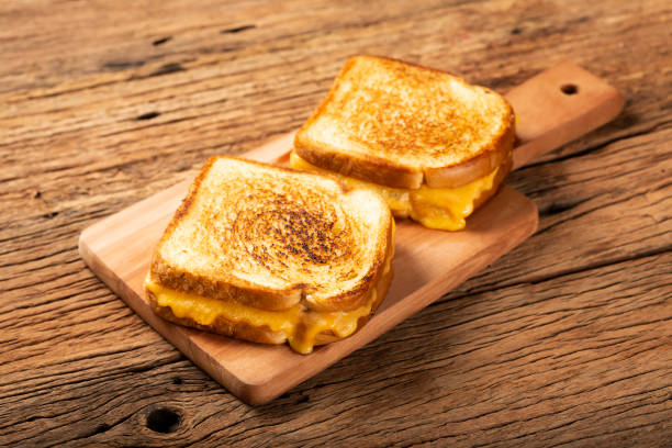 istock Grilled ham and cheese. Sandwich with cheese and ham on grill. 1313740001