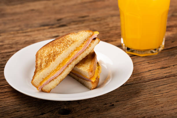 Grilled ham and cheese. Sandwich with cheese and ham on grill. Grilled ham and cheese. Sandwich with cheese and ham on grill. ham and cheese sandwich stock pictures, royalty-free photos & images