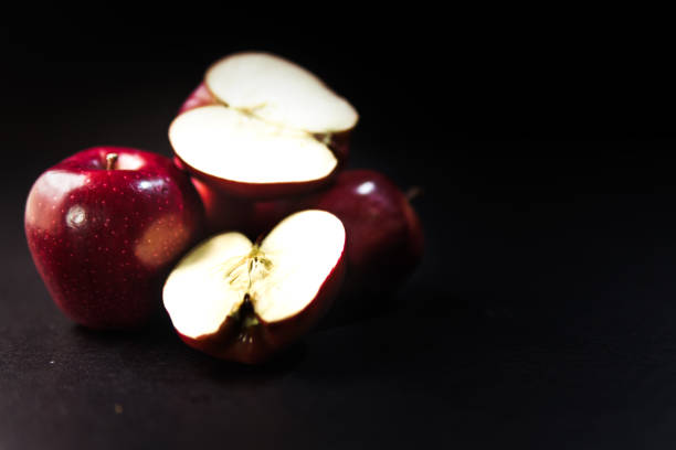 apple cut in half - red delicious apple stock-fotos und bilder