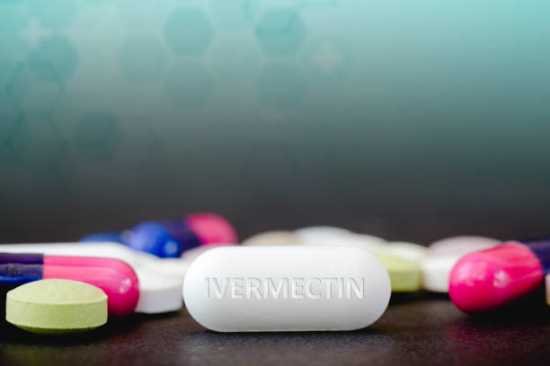 In this photo illustration medicine pills and the text IVERMECTIN in one pill. In this photo illustration medicine pills and the text IVERMECTIN in one pill chemical formula photos stock pictures, royalty-free photos & images