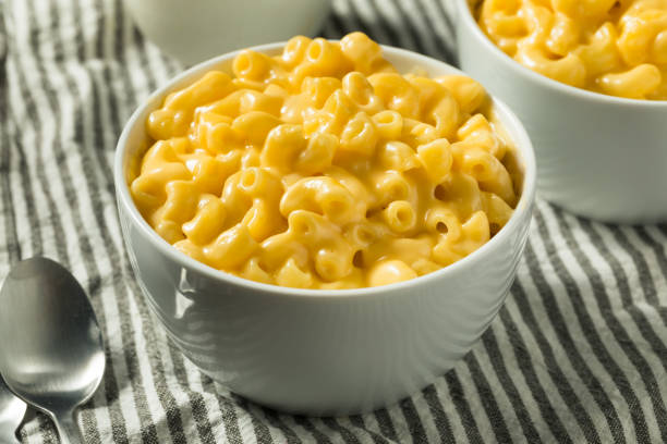 Homemade Creamy Macaroni and Cheese Pasta Homemade Creamy Macaroni and Cheese Pasta in a Bowl cheesy grin photos stock pictures, royalty-free photos & images