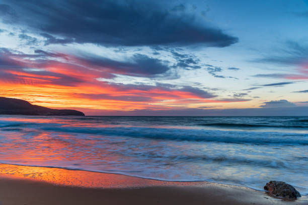 istock Sunrise at the seaside with pastel coloured clouds 1313741283
