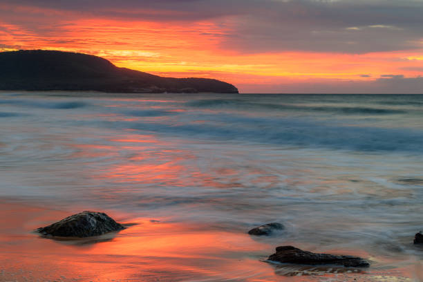 istock Sunrise at the seaside with pastel coloured clouds 1313741330