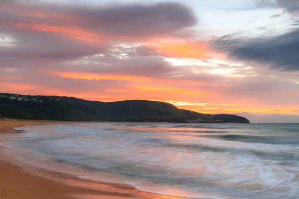 istock Sunrise at the seaside with pastel coloured clouds 1313741868