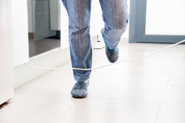 istock woman legs stumbling with an electrical cord 1313743544