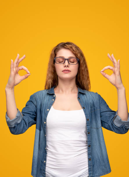 istock Calm woman meditating with closed eyes 1313744312