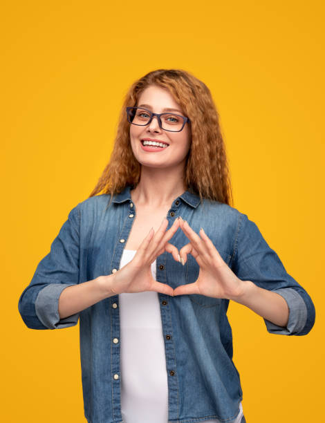 istock Cheerful female gesturing heart and smiling 1313744313
