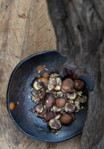 istock The remaining chestnuts in black ceramic plate on old rustic wooden background. 1313745332