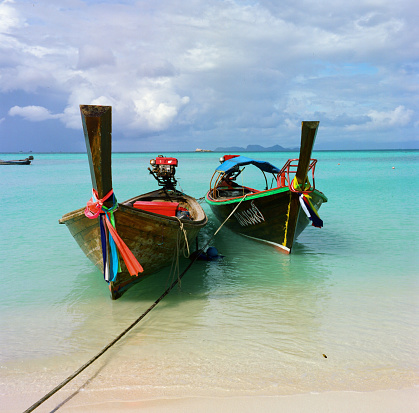 Long-tail boats are moored at the Sunrise beach on Koh Lipe, Satun province. Located 60 kilometres of the mainland, the island, being part of Tarutao Marine park, is abundant with sea life and is an extremely popular destination for divers.