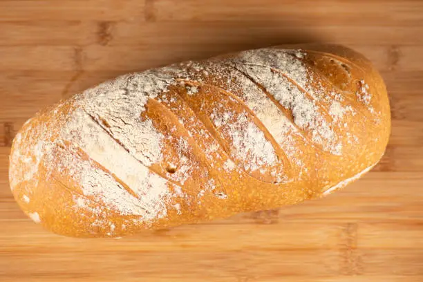 Detailed closeup of a scored Pane Di Casa bread loaf.