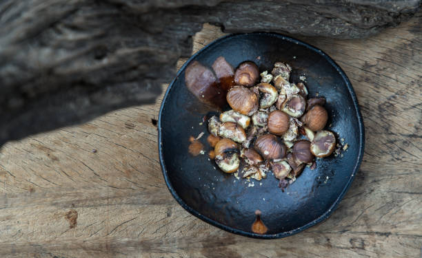 istock The remaining chestnuts in black ceramic plate on old rustic wooden background. 1313756293