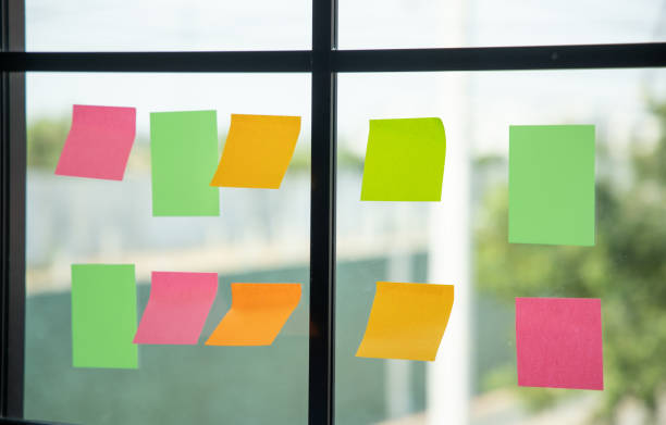 istock Colorful of post on the wall. sticky note or paper note on the windows for note what to do in the office. 1313758894