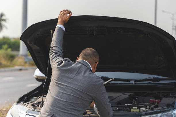 istock Young asian business has broken down car. He open hood and check the engine. He feeling upset and stressed. Car broken on the side of the road 1313758898