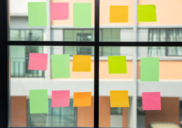 istock Colorful of post on the wall. sticky note or paper note on the windows for note what to do in the office. 1313758914