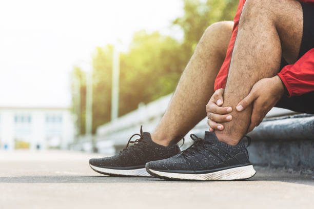 istock A runner has sore ankles because he ran too long. Exercising until the injury 1313759804