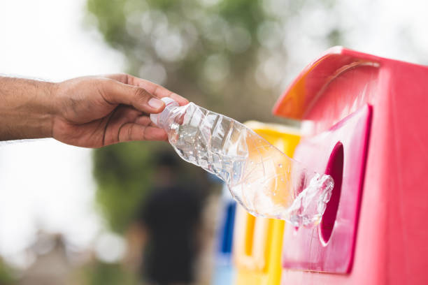 istock A young man drinks from plastic bottles and throws them into the trash. Video about environmental day Separate plastic waste in the correct category. Public trash 1313759845
