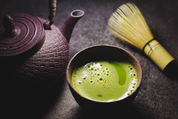 Matcha Tea with Kettle Green matcha tea powder in cups with traditional iron kettle. matcha tea photos stock pictures, royalty-free photos & images