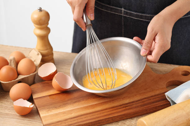 istock Young woman cooking omelet on wooden table 1313764174