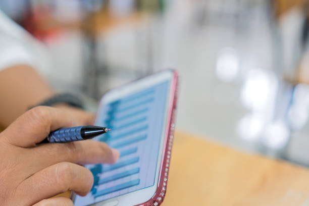 istock Businesswoman Using touch screen application digital smartphone for checking report graph in business document online from social media at modern office, Technology information in new normal work 1313764394