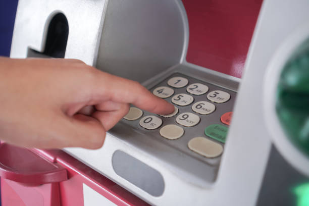 istock Press ATM PIN, Finger entering PIN pass code on Bank Machine Keypad. Automated teller machine is electronic telecommunications device that enables customers of financial institutions to transactions 1313764411