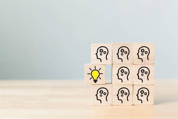 istock Concept creative idea and innovation. Wooden cube block with head human symbol and light bulb icon 1313768231