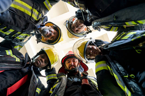 istock Low Angle View of Firefighters Huddling in Fire Station 1313773468