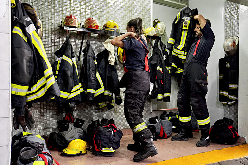 Indigenous Navajo Young Firefighter in front of fire engine truck at the station