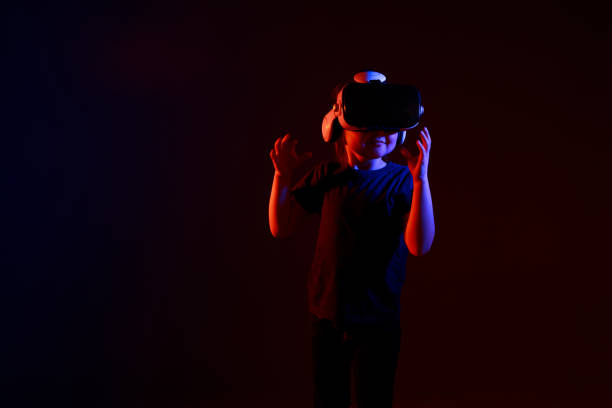 istock Little girl experiencing VR headset game on colorful background 1313776844