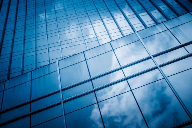 istock Blue sky and clouds reflected at glass wall 1313777711