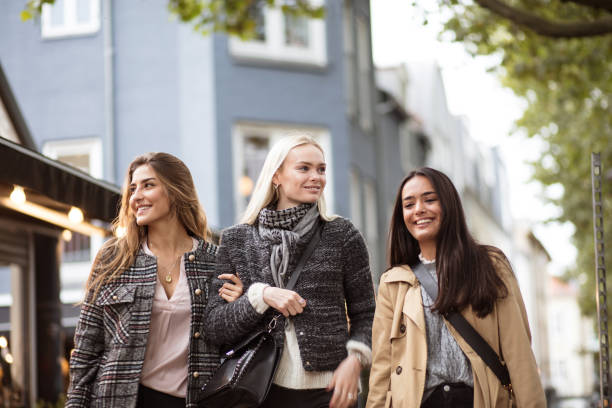 istock Three young women walking together trough city. 1313779713
