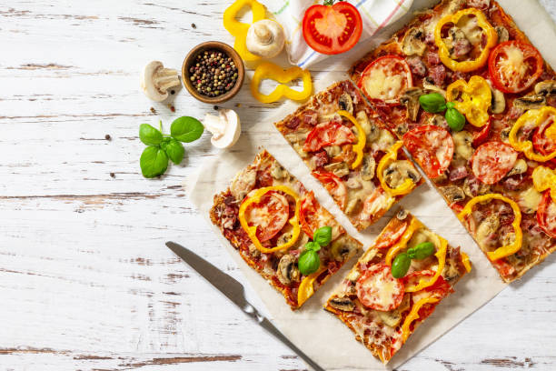 istock Home made baking. Detroit-Style Pizza. Large rectangular Pepperoni pizza with tomatoes, salami and cheese on a rustic wooden table. Top view. Flat lay. Copy space. 1313781650
