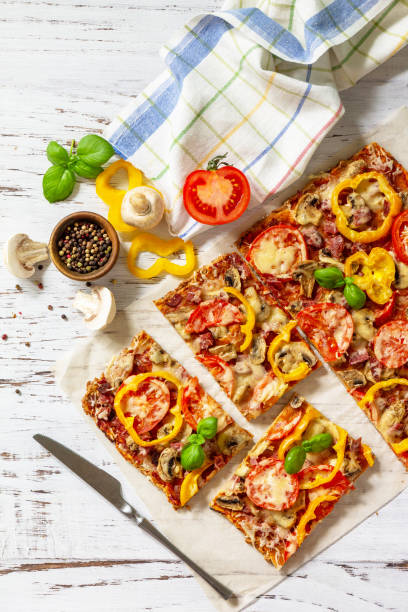 istock Home made baking. Detroit-Style Pizza. Large rectangular Pepperoni pizza with tomatoes, salami and cheese on a rustic wooden table. Top view. Flat lay. 1313781656