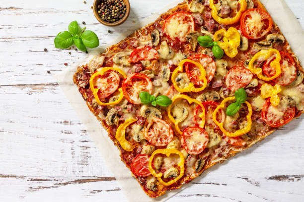 istock Home made baking. Detroit-Style Pizza. Large rectangular Pepperoni pizza with tomatoes, salami and cheese on a rustic wooden table. Top view. Flat lay. Copy space. 1313781664
