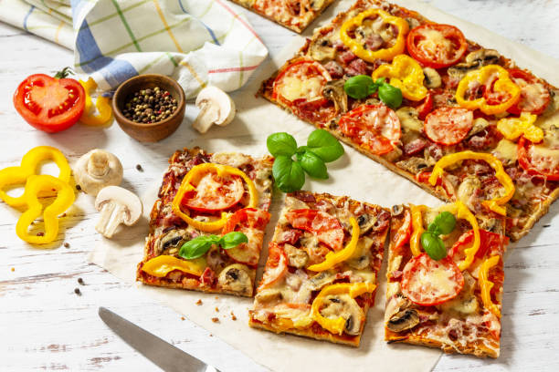 istock Home made baking. Detroit-Style Pizza. Large rectangular Pepperoni pizza with tomatoes, salami and cheese on a rustic wooden table. 1313781669