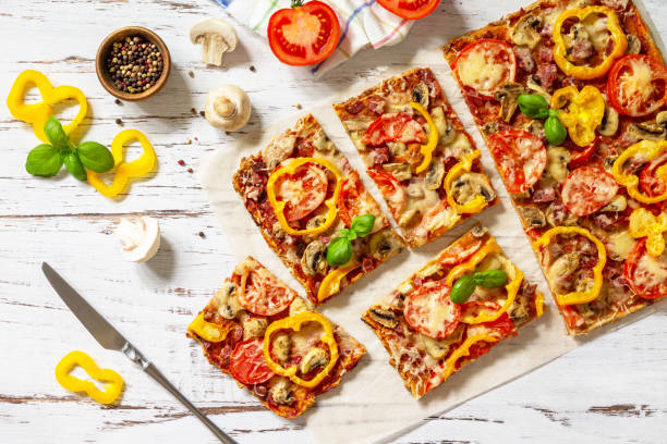 istock Home made baking. Detroit-Style Pizza. Large rectangular Pepperoni pizza with tomatoes, salami and cheese on a rustic wooden table. Top view. Flat lay. 1313781670