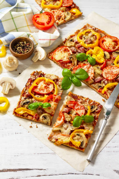 istock Home made baking. Detroit-Style Pizza. Large rectangular Pepperoni pizza with tomatoes, salami and cheese on a rustic wooden table. Copy space. 1313781674