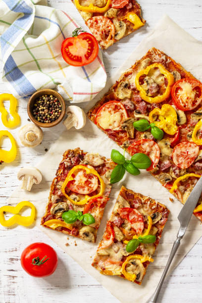istock Home made baking. Detroit-Style Pizza. Large rectangular Pepperoni pizza with tomatoes, salami and cheese on a rustic wooden table. Top view. Flat lay. 1313781685