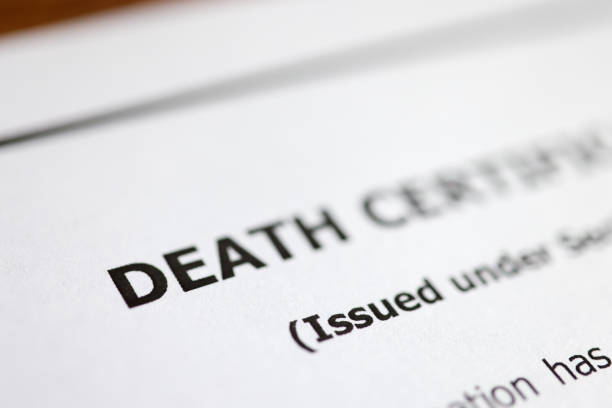 istock Death certificate is on table. Paperwork after death of relative 1313782535