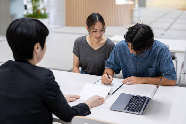 istock Asian married couple consulting with agent 1313782632