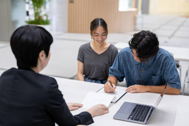 istock Asian married couple consulting with agent 1313782635